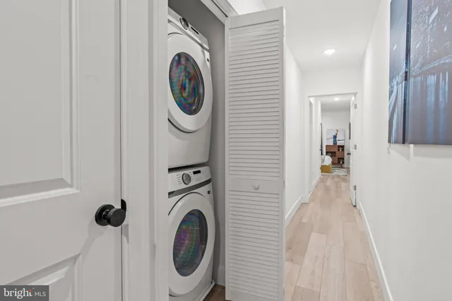 a view of a hallway with washer and dryer