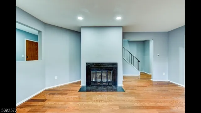 a view of a kitchen with refrigerator and wooden floor