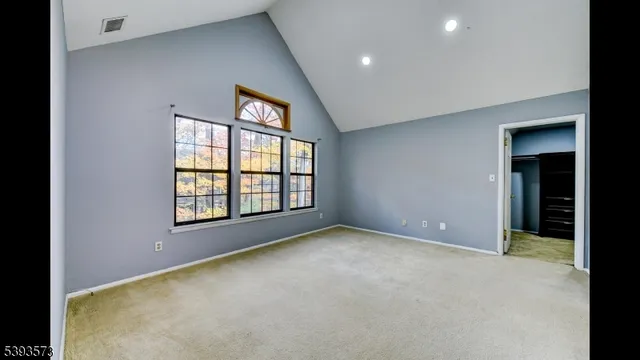 a view of a big room with closet and front door