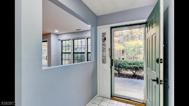 a view of a room that has a large window and an outdoor view