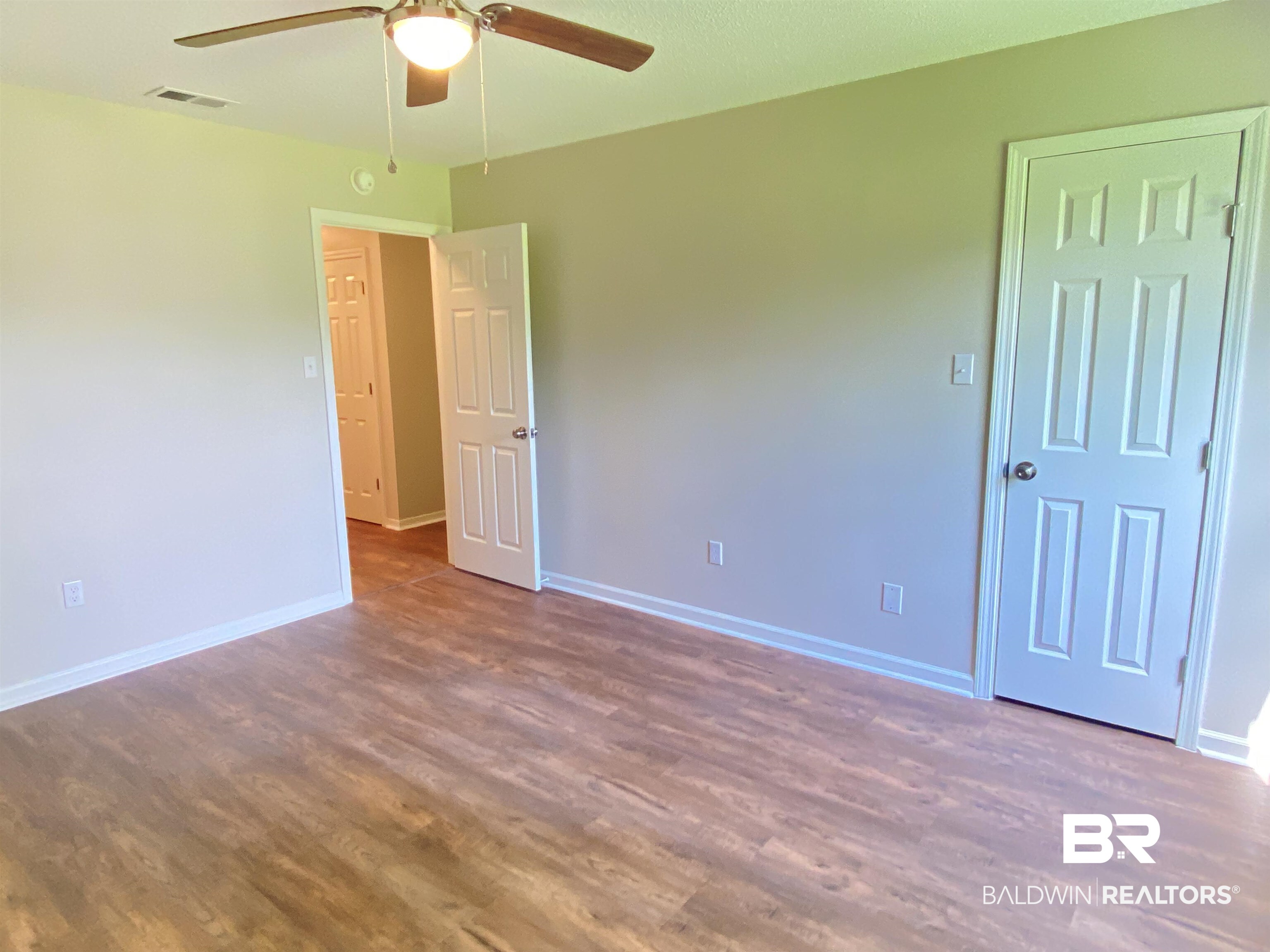 12150 Lee Bishop Road Irvington, AL 36544 - Photo 23 of 26 Unfurnished room with a ceiling fan, baseboards, visible vents, and wood finished floors