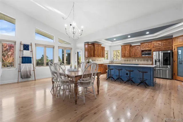 a large kitchen with a table and chairs