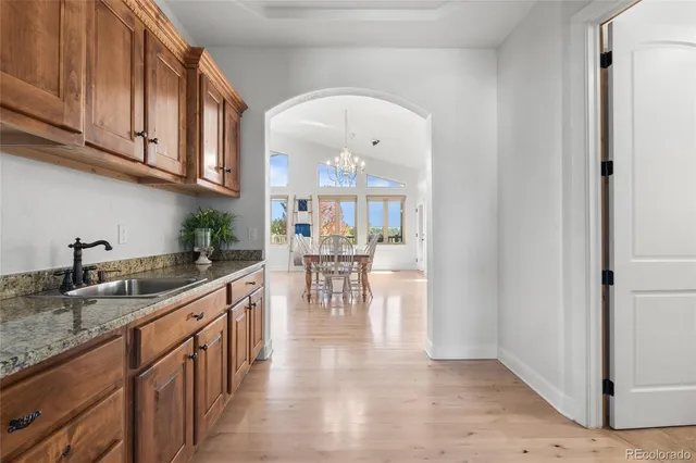 a kitchen with stainless steel appliances granite countertop a refrigerator and a sink