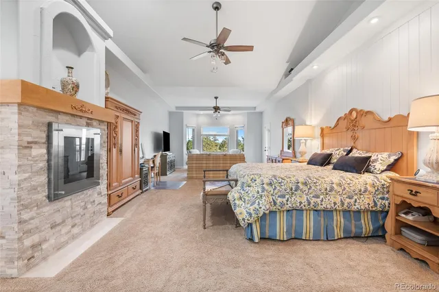 a bedroom with a bed and ceiling fan