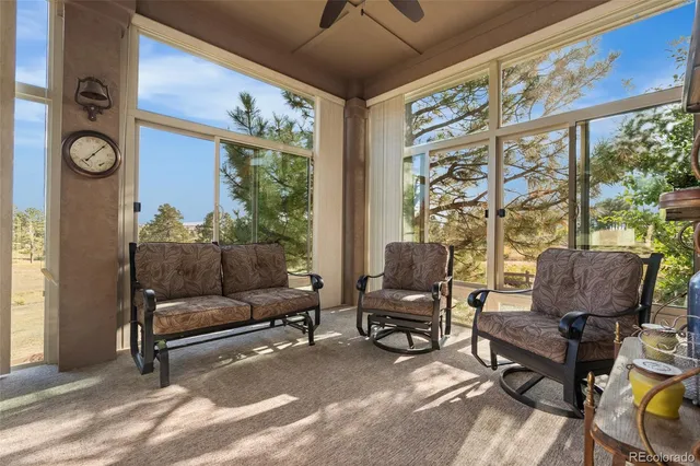 a living room with furniture and a floor to ceiling window