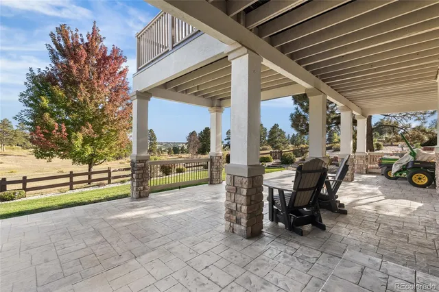 a view of a patio with table and chairs and potted plants