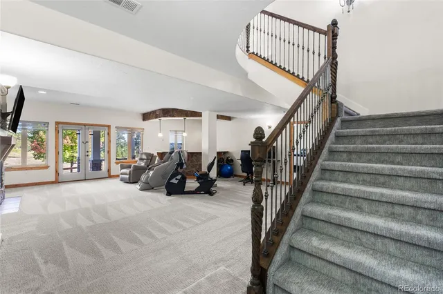 a view of a livingroom with furniture and staircase