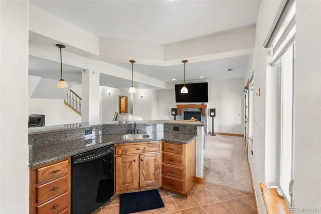 a kitchen with granite countertop a sink appliances and cabinets