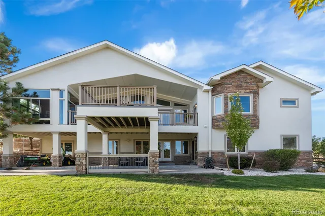 a front view of a house with swimming pool having outdoor seating