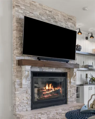 a living room with a fireplace and a fireplace