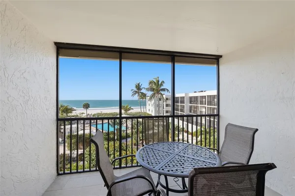 a view of a balcony with furniture