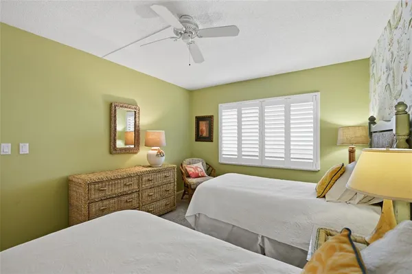 a bedroom with two beds and a window