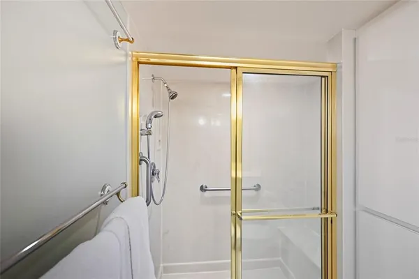 a bathroom with a glass shower door and a bathtub