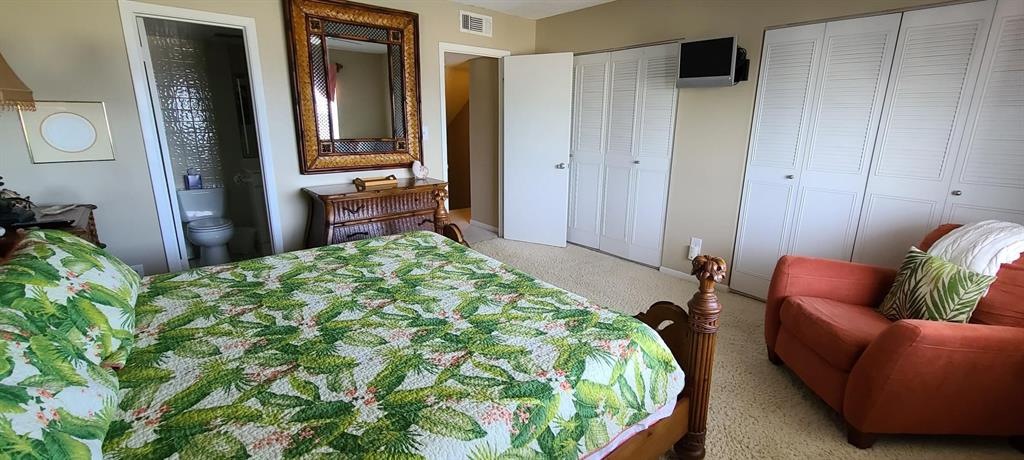 815 Ocean Shore Boulevard, Unit 7A Ormond Beach, FL 32176 - Photo 12 of 16 a bedroom with a bed and a couch
