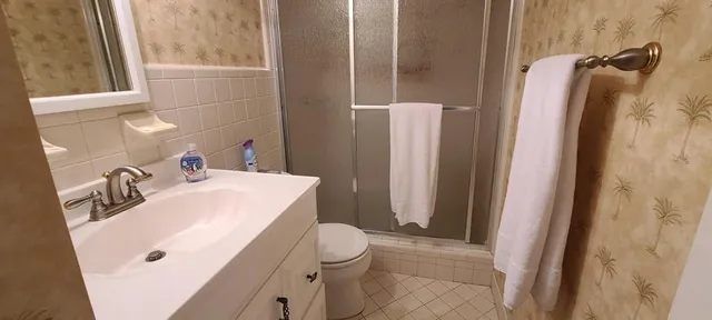 a bathroom with a sink vanity mirror and toilet
