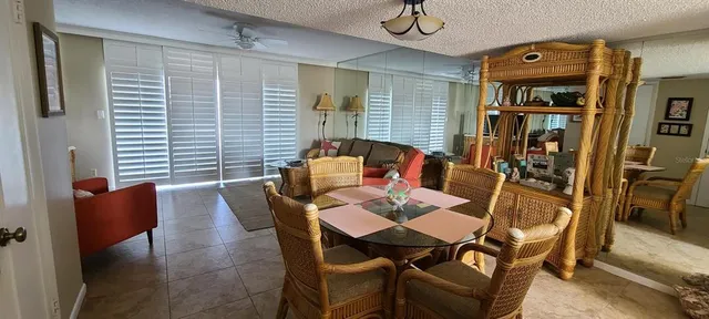 a dining room with furniture and wooden floor