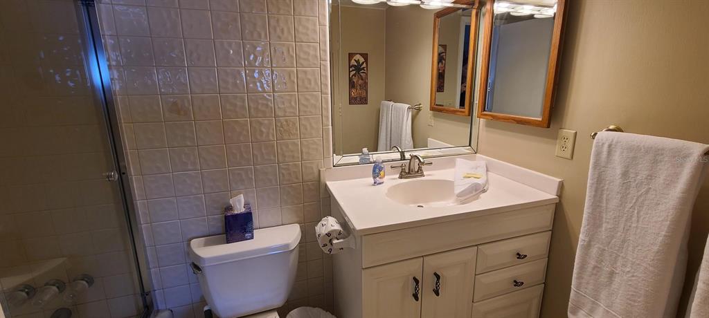 815 Ocean Shore Boulevard, Unit 7A Ormond Beach, FL 32176 - Photo 15 of 16 a bathroom with a sink toilet and mirror