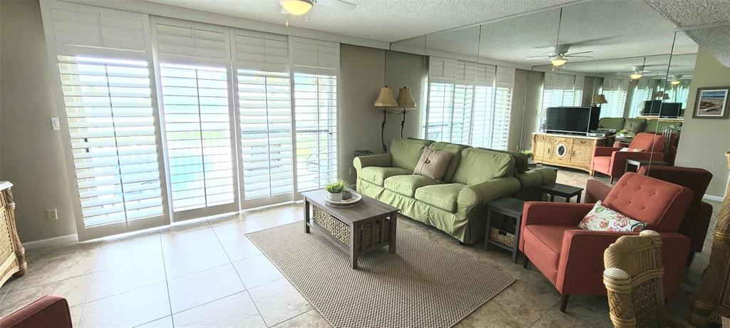 815 Ocean Shore Boulevard, Unit 7A Ormond Beach, FL 32176 - Photo 2 of 16 a living room with furniture and a large window