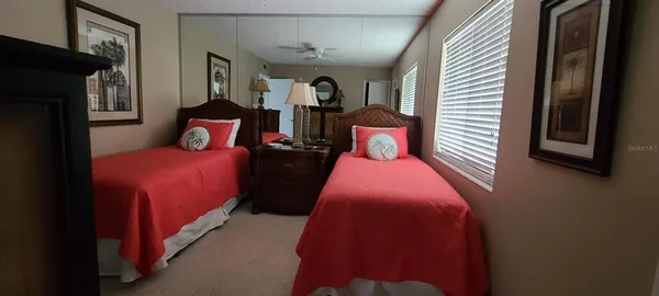 a bed room with a bed and a potted plant