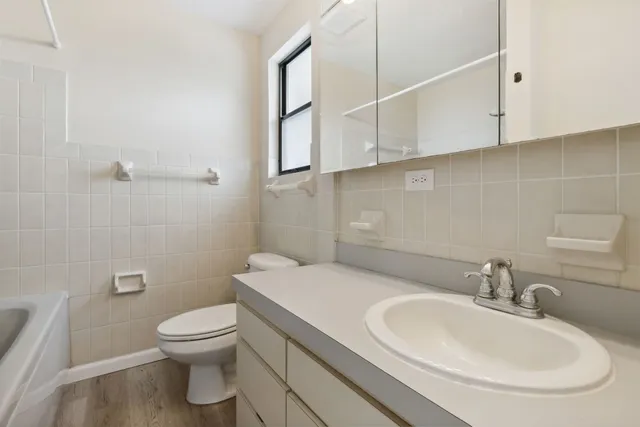 a bathroom with a sink a toilet and mirror