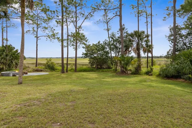 a swimming pool with outdoor seating and yard