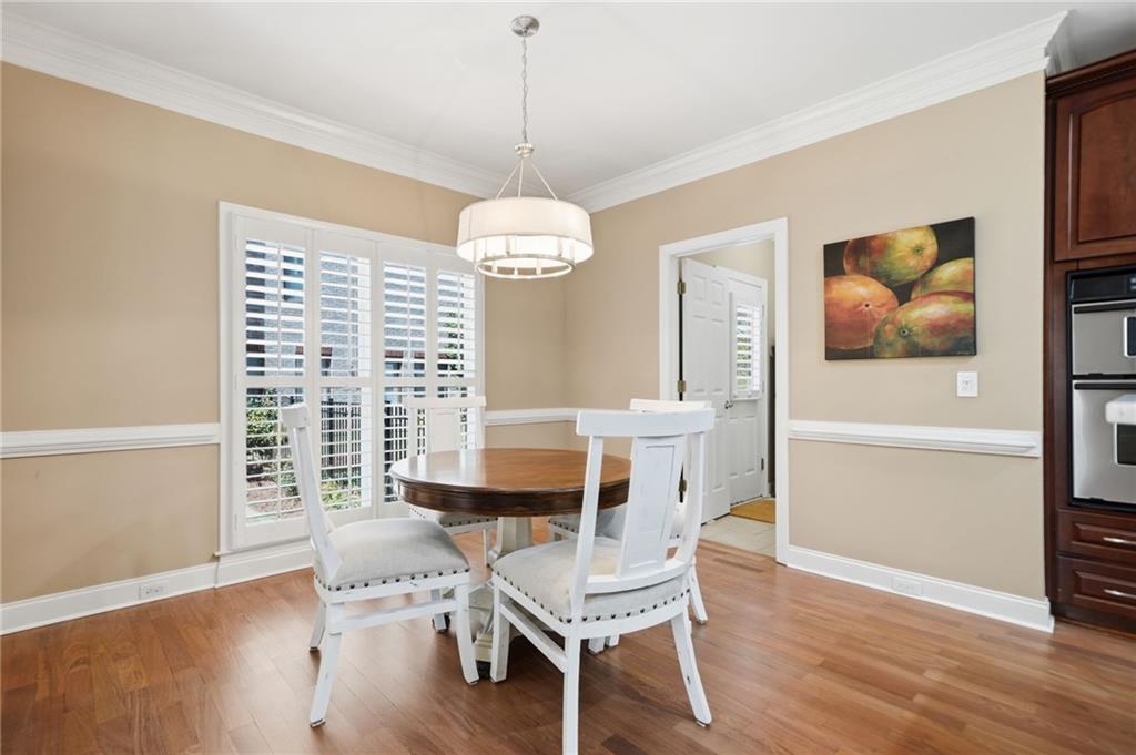 4147 Gold Mill Ridge Canton, GA 30114 - Photo 21 of 93 a view of a dining room with furniture window and wooden floor
