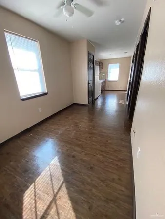 wooden floor in an empty room with a window