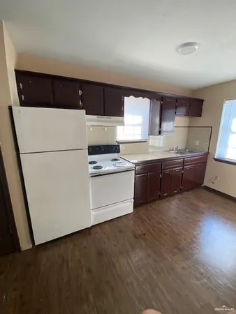 a kitchen with stainless steel appliances a refrigerator sink and white cabinets