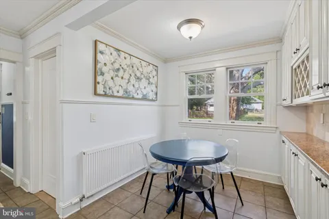 a view of a dining room with furniture and a window