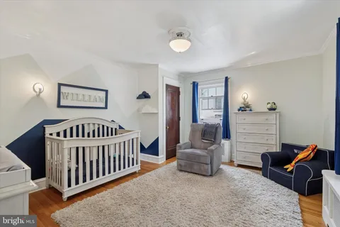 a bedroom with furniture and a baby crib