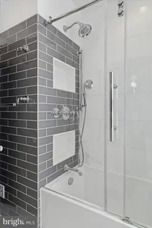 a bathroom with a bathtub and a shower