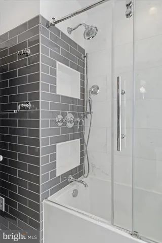 a bathroom with a bathtub and a shower