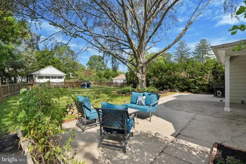 a view of backyard with outdoor seating and green space