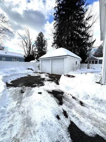 a view of a yard with snow on the road