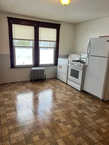 a kitchen with a stove and a refrigerator