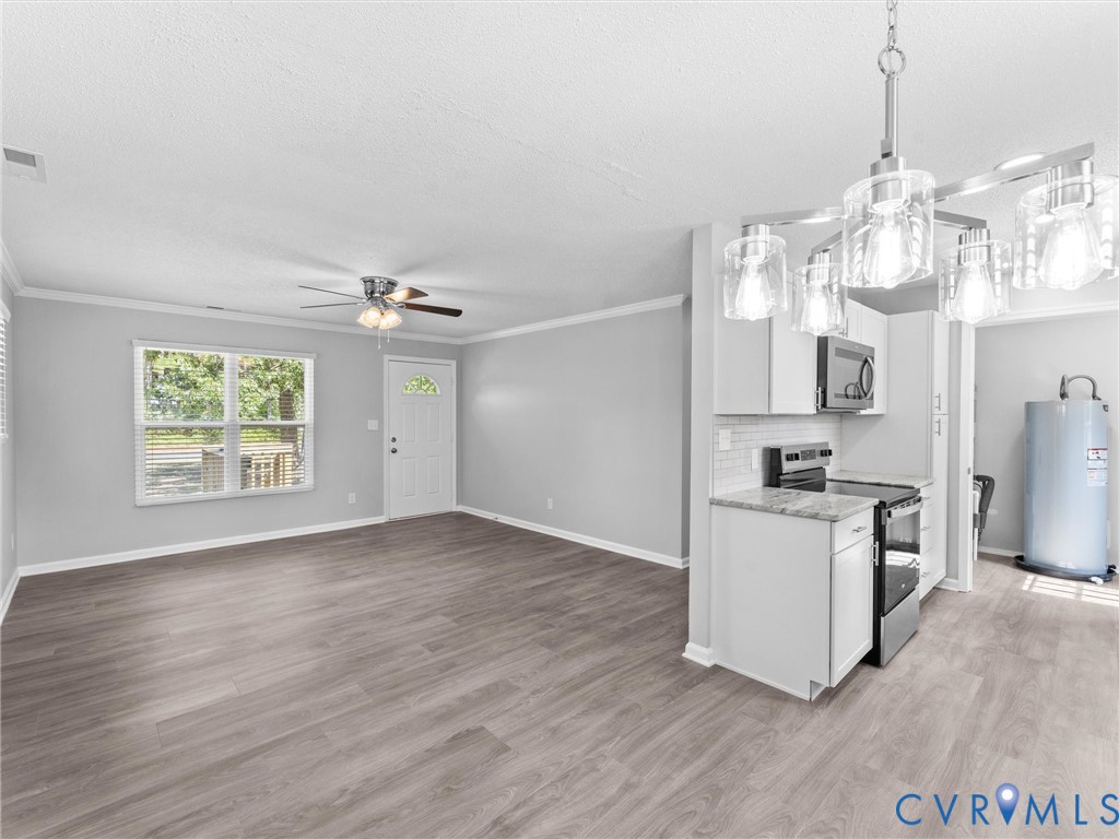 6927 Carsley Road Waverly, VA 23890 - Photo 11 of 51 Wood-finish flooring throughout, bright white trim