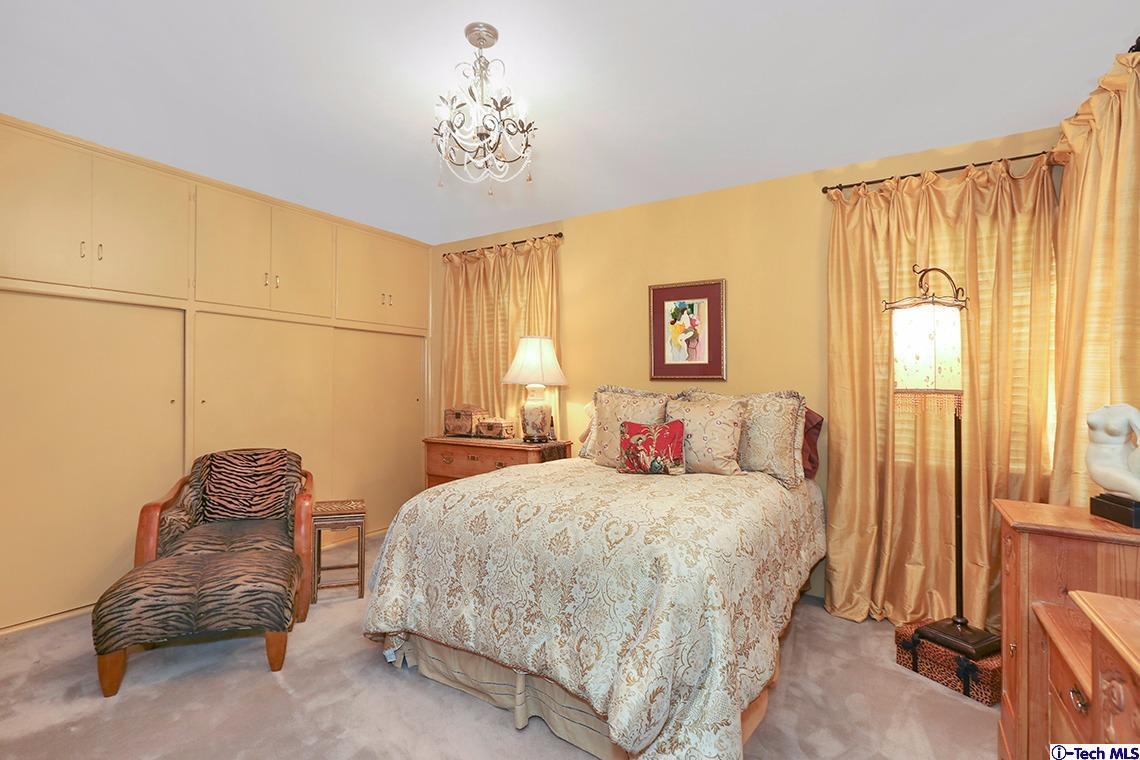 841 West Roses Road San Gabriel, CA 91775 - Photo 15 of 24 a bedroom with a bed and a chandelier