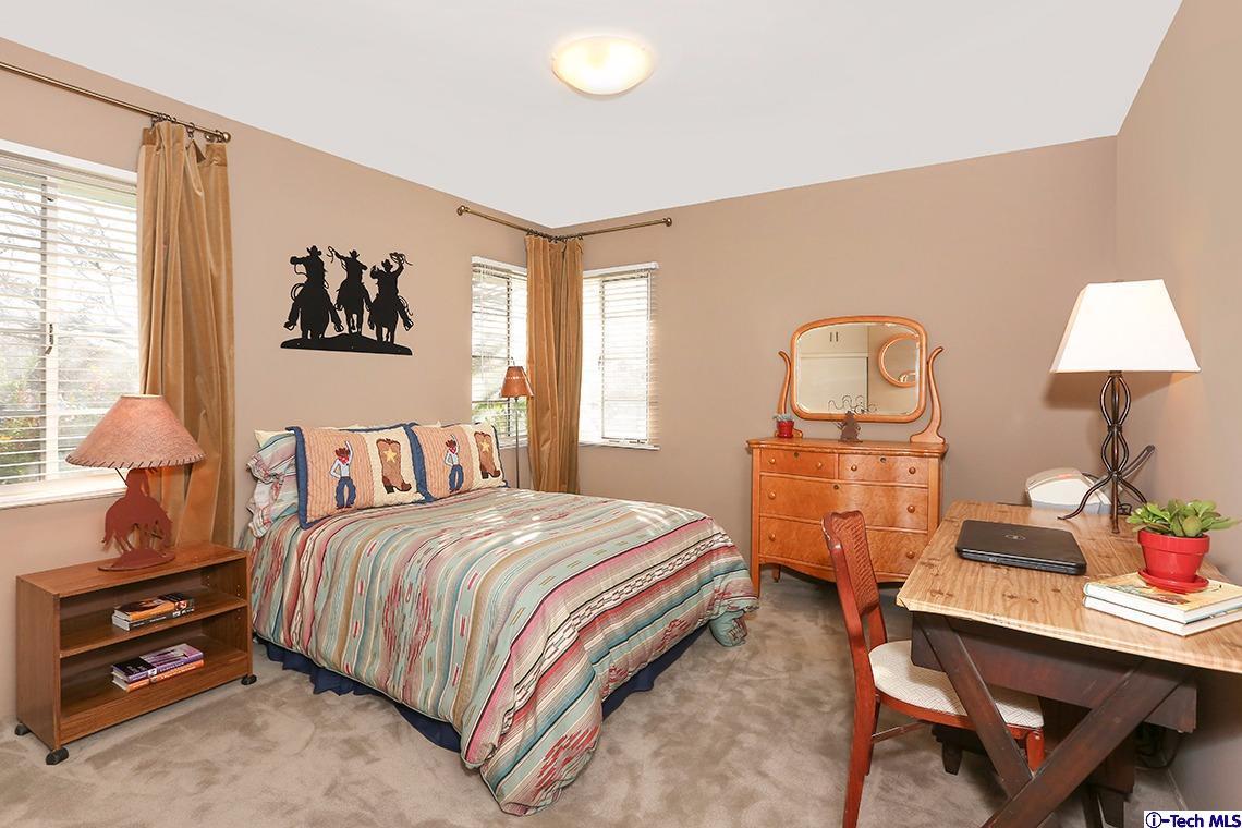 841 West Roses Road San Gabriel, CA 91775 - Photo 18 of 24 a bedroom with a bed and a table in it
