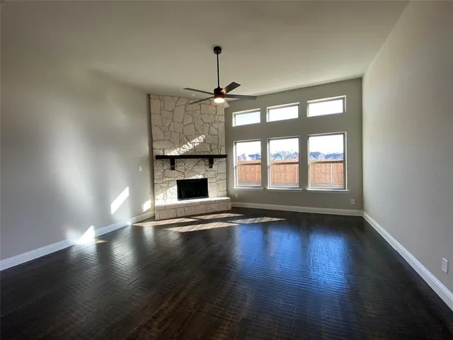 a living room with granite countertop a fireplace a flat screen tv and a fireplace