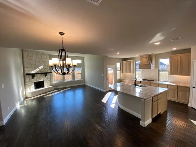 a view of staircase with wooden floor and a chandelier