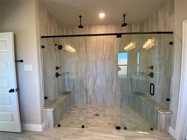 a large bathroom with a granite countertop sink a toilet a mirror and a tub