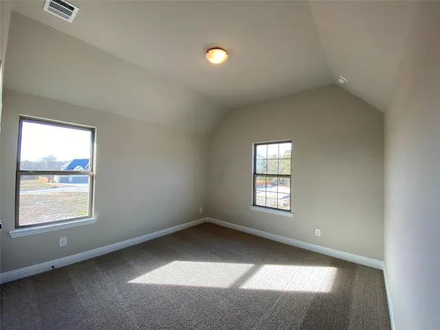 a bathroom with a granite countertop sink a toilet a mirror and shower