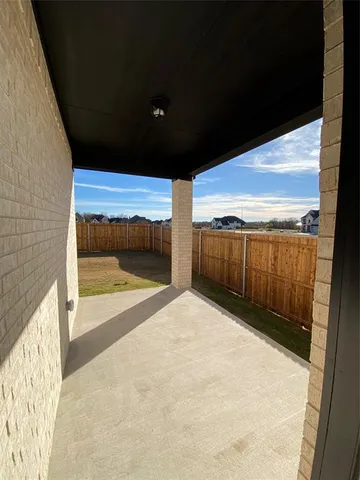 a view of a backyard with wooden fence