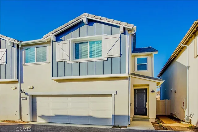 a view of a house with wooden fence and large windows