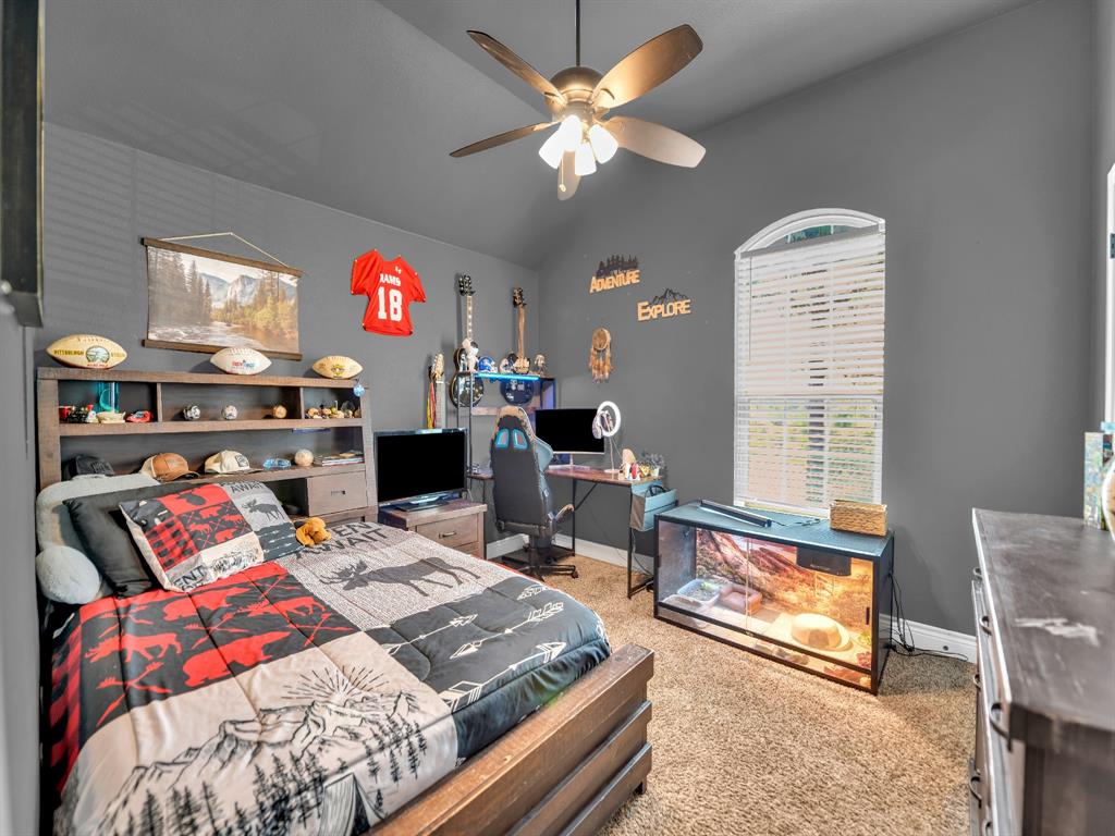 156 Cottongame Road Weatherford, TX 76088 - Photo 23 of 35 a bedroom with furniture and a fireplace