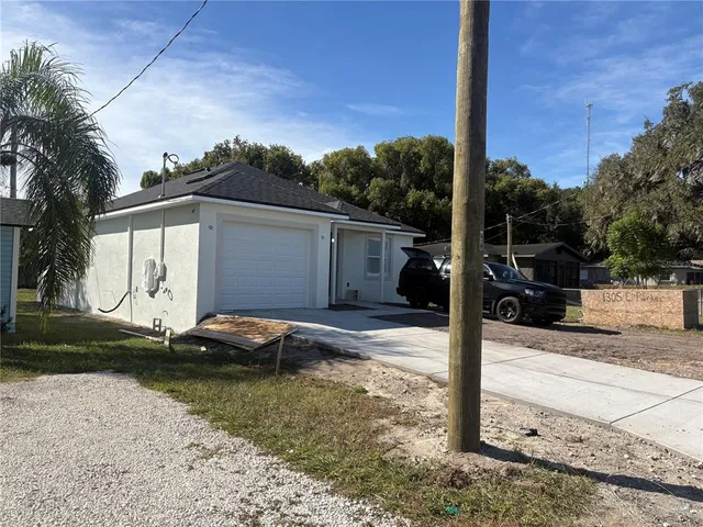 a backyard of a house with yard fire pit and outdoor seating
