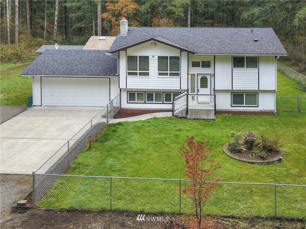 7370 Bordeaux Road Southwest Olympia, WA 98512 - Photo 1 of 25 a front view of a house with a garden and yard