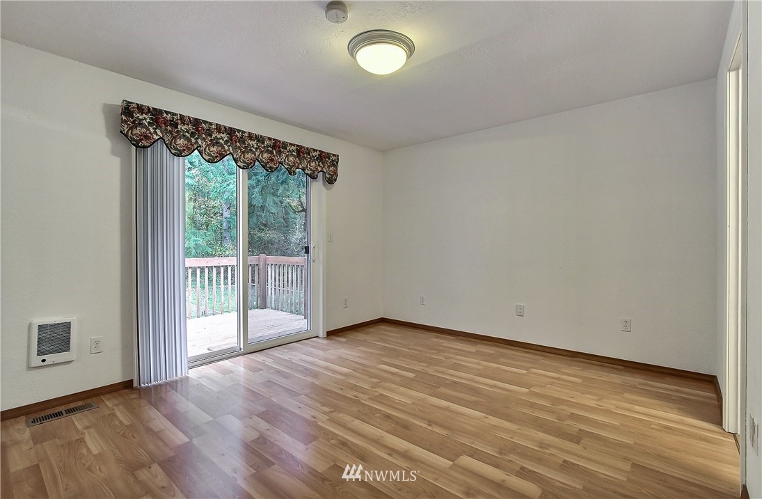 7370 Bordeaux Road Southwest Olympia, WA 98512 - Photo 12 of 25 a view of an empty room with wooden floor and a window