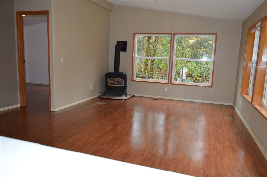 7370 Bordeaux Road Southwest Olympia, WA 98512 - Photo 23 of 25 a view of an empty room with wooden floor and a window