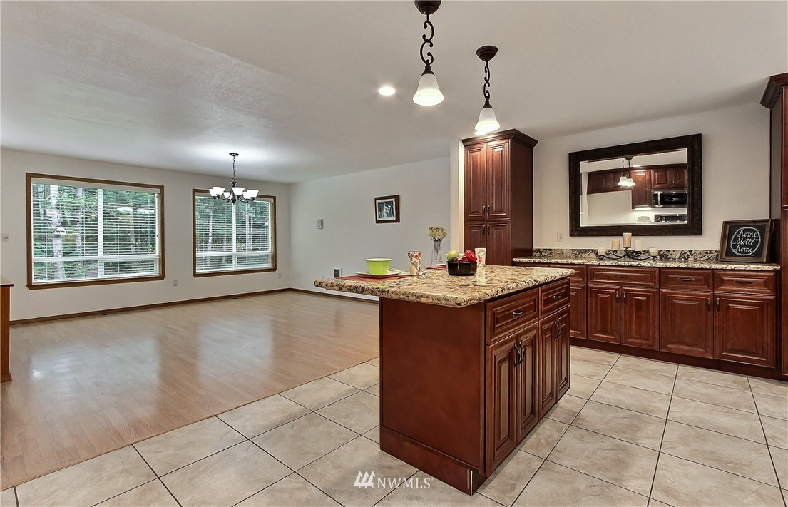 7370 Bordeaux Road Southwest Olympia, WA 98512 - Photo 7 of 25 a kitchen with stainless steel appliances granite countertop a stove a sink and a wooden cabinets